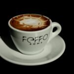 Close-up of a cappuccino with intricate latte art in a Rome café. Ideal stock photo for coffee enthusiasts.