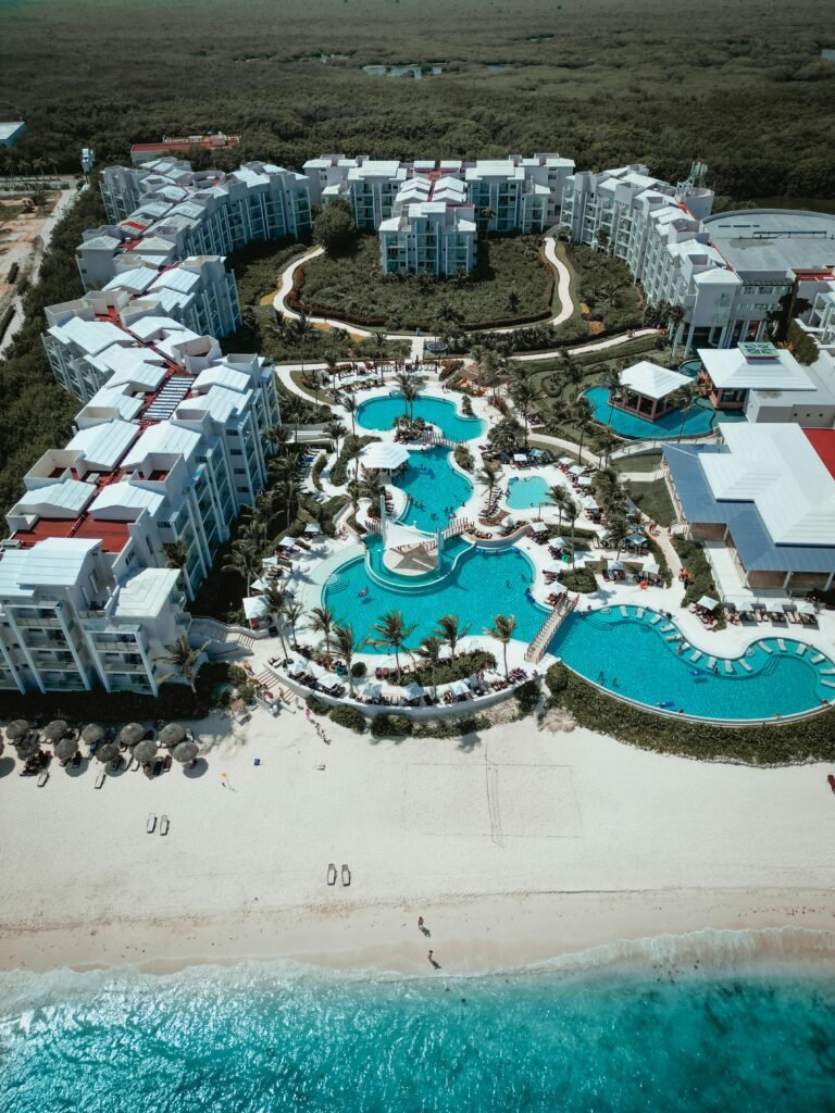 Aerial shot of a beachfront resort with stunning pools and lush surroundings in Puerto Morelos.